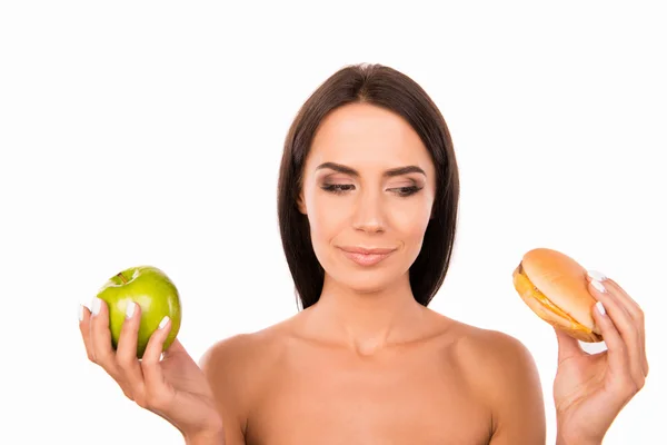 Happy young woman deciding between organic and harmful nutrition — Stock Photo, Image