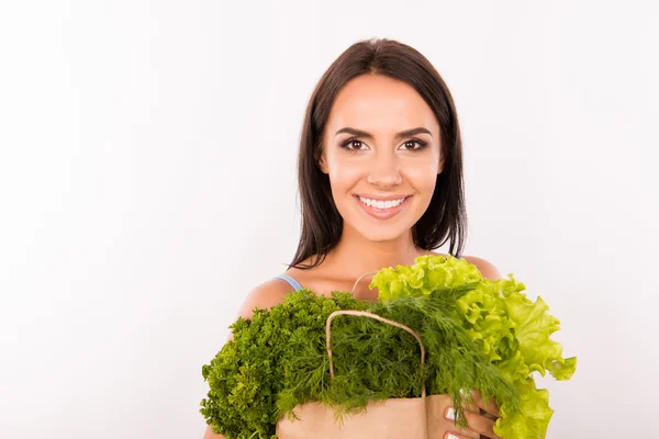 Happy woman with bag full of greens and vegetables — Stock Photo, Image