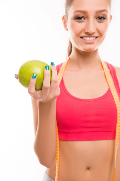 Close-up portrait of young girl with apple and measuring tape — Stock Photo, Image