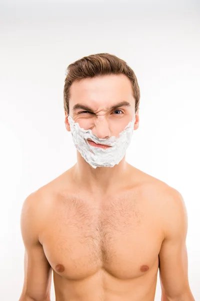 Handsome upset man with shaving foam on his face — Stock Photo, Image