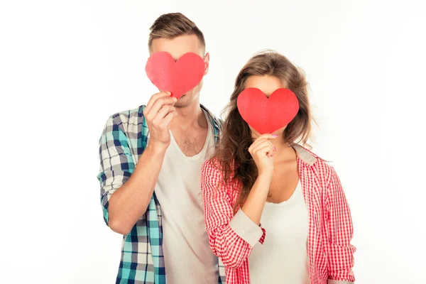 Happy couple in love embracing each other hiding faces behind tw — Stock Photo, Image