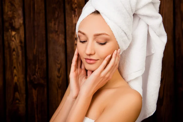 Young cute girl with towel on her head in spa salon — Stock Photo, Image