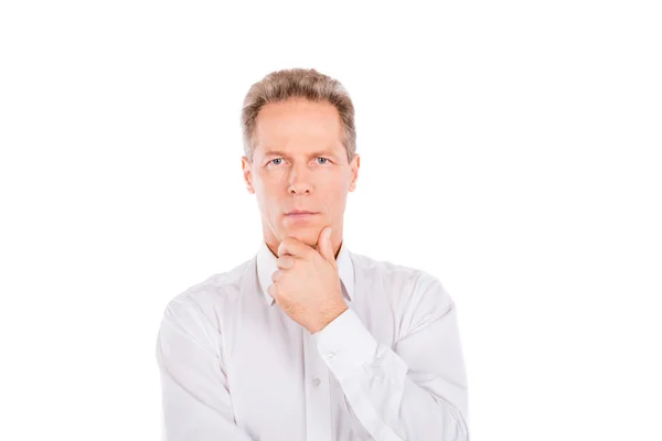 A mature man in a shirt with a hand on his chin — Stock Photo, Image