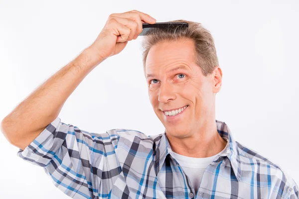 Handsome funny happy aged man combing his hair — Stock Photo, Image