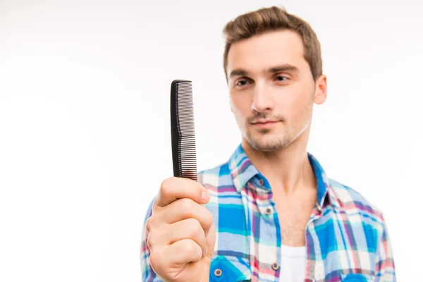 Handsome man holding a comb — Stock Photo, Image