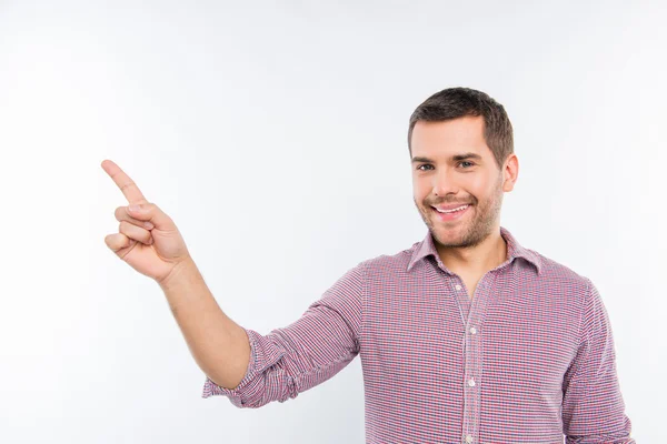 Cheerful young man pointing away — Stock Photo, Image