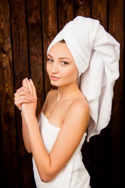Young attractive girl with towel on her head in spa salon clipart