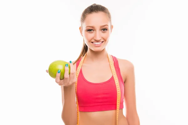 Deportiva chica con cinta métrica y manzana verde — Foto de Stock
