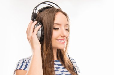 Happy pretty girl enjoying music on headphones  clipart