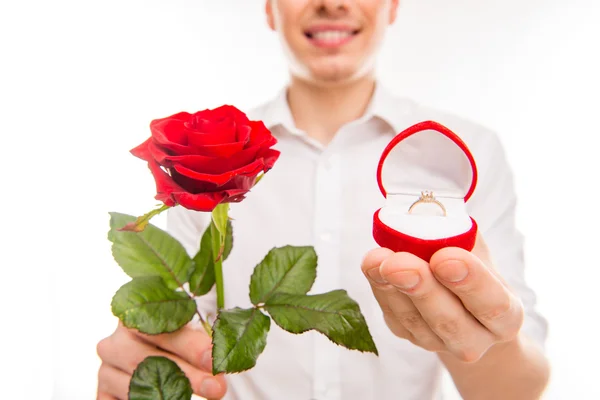 Close up photo of a handsome man with a red rose and wedding rin — Stock Photo, Image