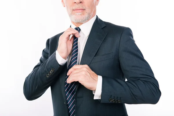 Close up portrait of old businessman correcting his tie — Stock Photo, Image