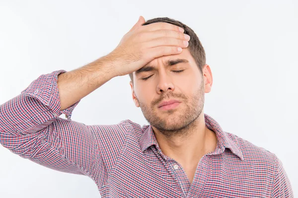 Handsome young man touching his head with one hand feeling stron — Stock Photo, Image