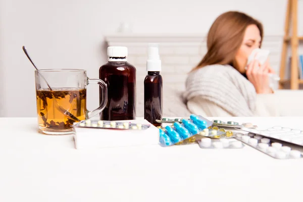 Sick woman, cup of tea, pills and mixture, close up photo — Stock Photo, Image