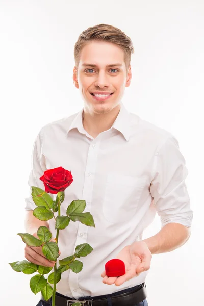 Portrait of handsome man with a red rose and wedding ring — Stock Photo, Image