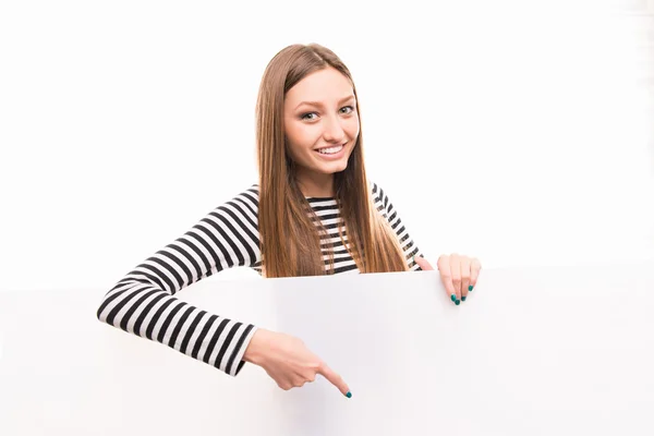 Positive happy girl pointing down to the empty space — Stock Photo, Image