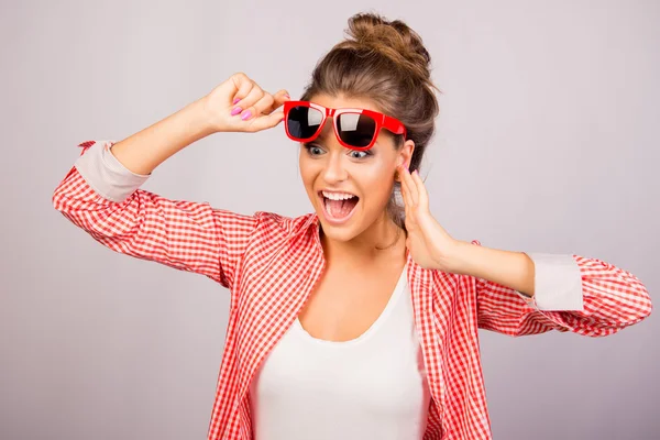 A young beautiful girl in glasses pleasantly surprised — Stock Photo, Image