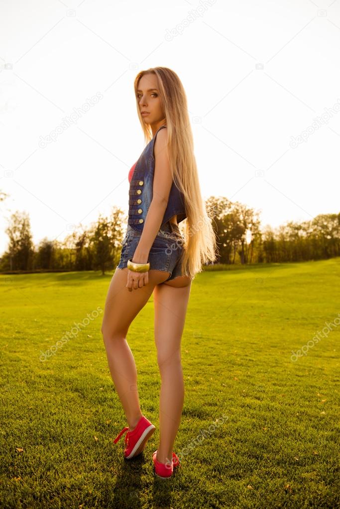 girl with sexy buttoks mini shorts walking in the pa Stock Photo by ©deagreez1 98947996