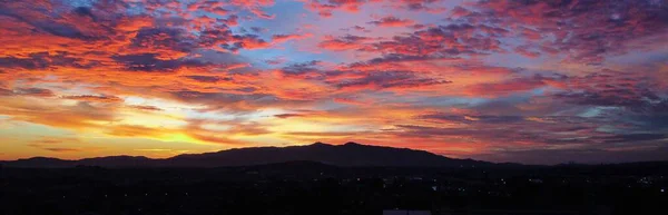 dramatic sky over a mountain during sunset