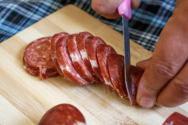 Close Man Hand Slicing Turkish Sausage Raw Sausage Chopping Board — Stock Photo, Image