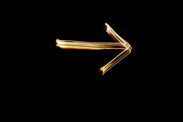 Signo Flecha Pintura Ligera Forma Flecha Dibujada Con Luces Oro — Foto de Stock