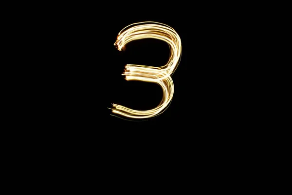 Nummer Langzeitbelichtungsfoto Von Goldlichtern Lichtmalerei Nummer Drei Auf Schwarzem Hintergrund — Stockfoto