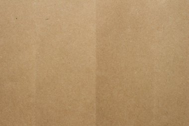 Brown kraft paper texture with fold lines. Detailed cardboard surface showing intersecting creases and natural fiber patterns.