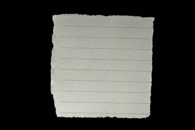 Piece of ripped torn lined paper on black background, paper cut out design element
