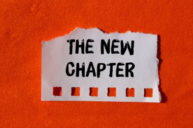 The new chapter message written on ripped torn paper background. Conceptual The new chapter symbol. Copy space.