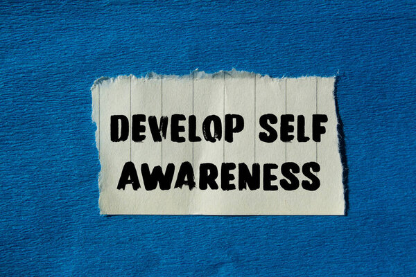 Develop self awareness message written on ripped torn paper background. Conceptual Develop self awareness symbol. Copy space.