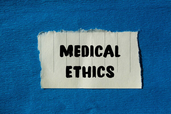 Medical ethics message written on ripped torn paper background. Conceptual Medical ethics symbol. Copy space.