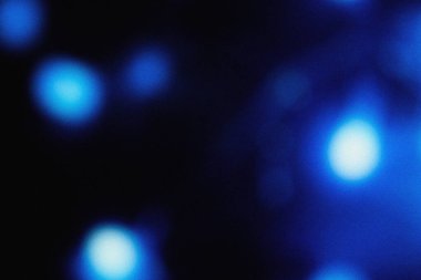 Soft blue illumination with cinematic blur and grainy dust overlay, creating an elegant modern background texture for design, film, and digital art projects