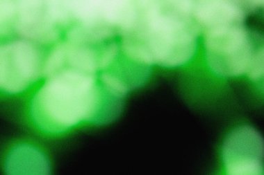 Soft green illumination with cinematic blur and grainy dust overlay, creating an elegant modern background texture for design, film, and digital art projects