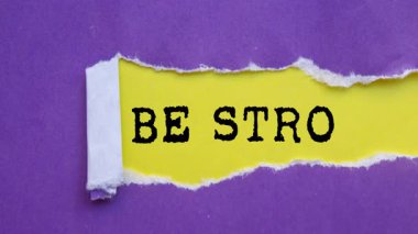 Be Strong message written on ripped torn paper background. Conceptual Be Strong symbol.