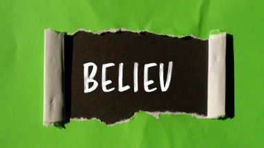 Believe message written on ripped torn paper background. Conceptual Believe symbol.