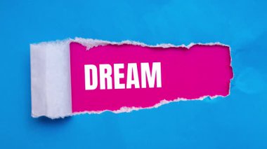 Dream Big message written on ripped torn paper background. Conceptual Dream Big symbol.