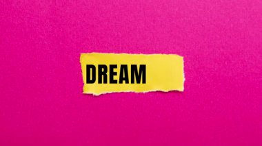Dream Big message written on ripped torn paper background. Conceptual Dream Big symbol.