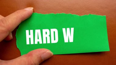 Hard Work message written on ripped torn paper background. Conceptual Hard Work symbol.