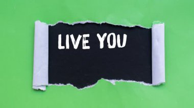 Live your values message writing on ripped torn paper background