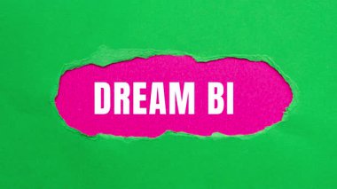Dream Big message written on ripped torn paper background. Conceptual Dream Big symbol.