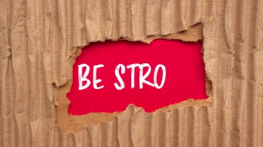Be Strong message written on ripped torn paper background. Conceptual Be Strong symbol.