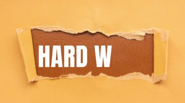 Hard Work message written on ripped torn paper background. Conceptual Hard Work symbol.