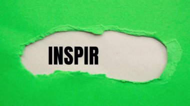 Inspiration message written on ripped torn paper background. Conceptual Inspiration symbol.