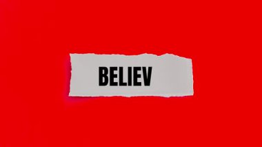 Believe message written on ripped torn paper background