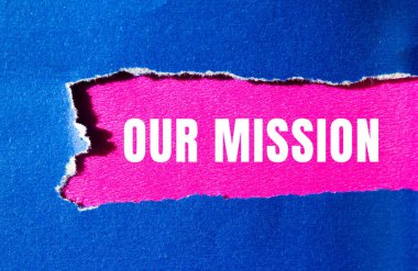 Our mission message written on ripped torn paper background. Conceptual Our mission symbol. Copy space.