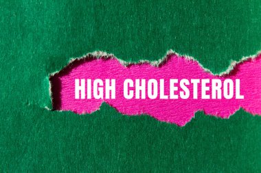 High cholesterol message written on ripped torn paper background. Conceptual High cholesterol symbol. Copy space.
