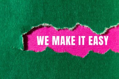 We make it easy message written on ripped torn paper background. Conceptual We make it easy symbol. Copy space.