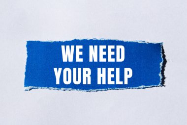 We need your help message written on ripped torn paper background. Conceptual We need your help symbol. Copy space.