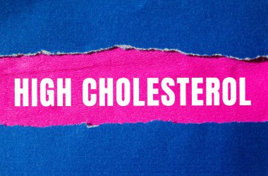 High cholesterol message written on ripped torn paper background. Conceptual High cholesterol symbol. Copy space.