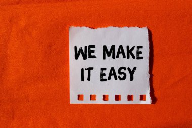 We make it easy message written on ripped torn paper background. Conceptual We make it easy symbol. Copy space.