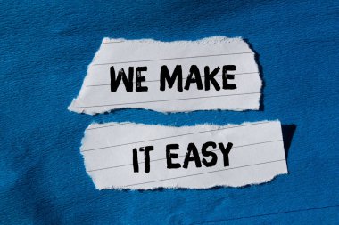 We make it easy message written on ripped torn paper background. Conceptual We make it easy symbol. Copy space.
